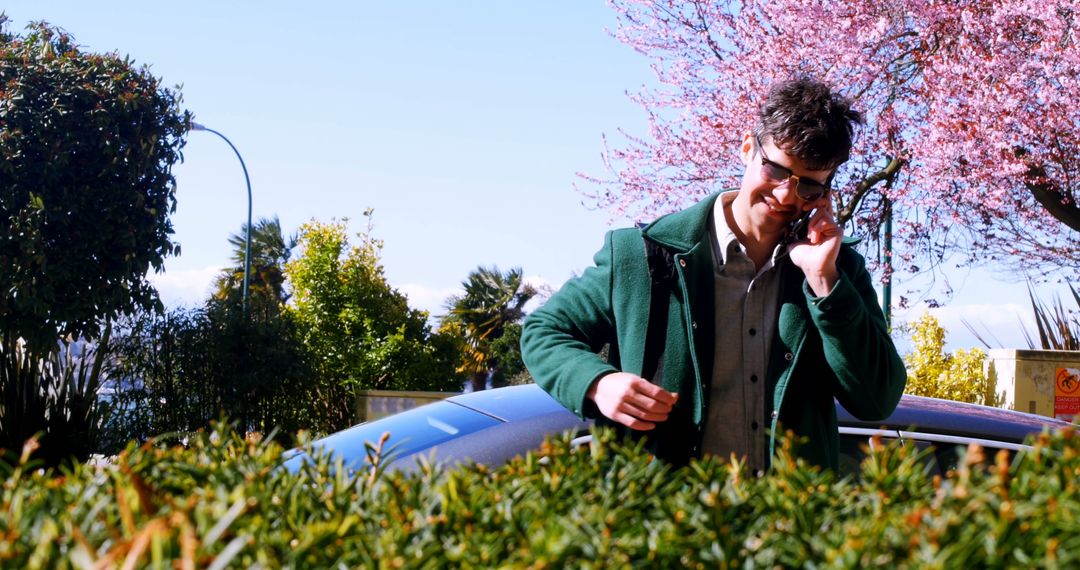 Man Having Phone Call Next to Car on Sunny Day - Free Images, Stock Photos and Pictures on Pikwizard.com