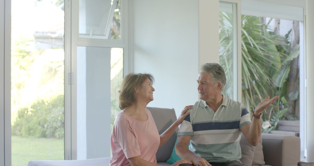 Senior Couple Engaging in Lighthearted Conversation at Home