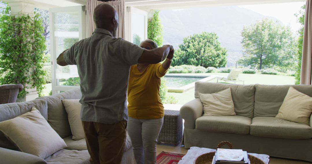 Senior Couple Dancing Joyfully in Cozy Living Room - Free Images, Stock Photos and Pictures on Pikwizard.com