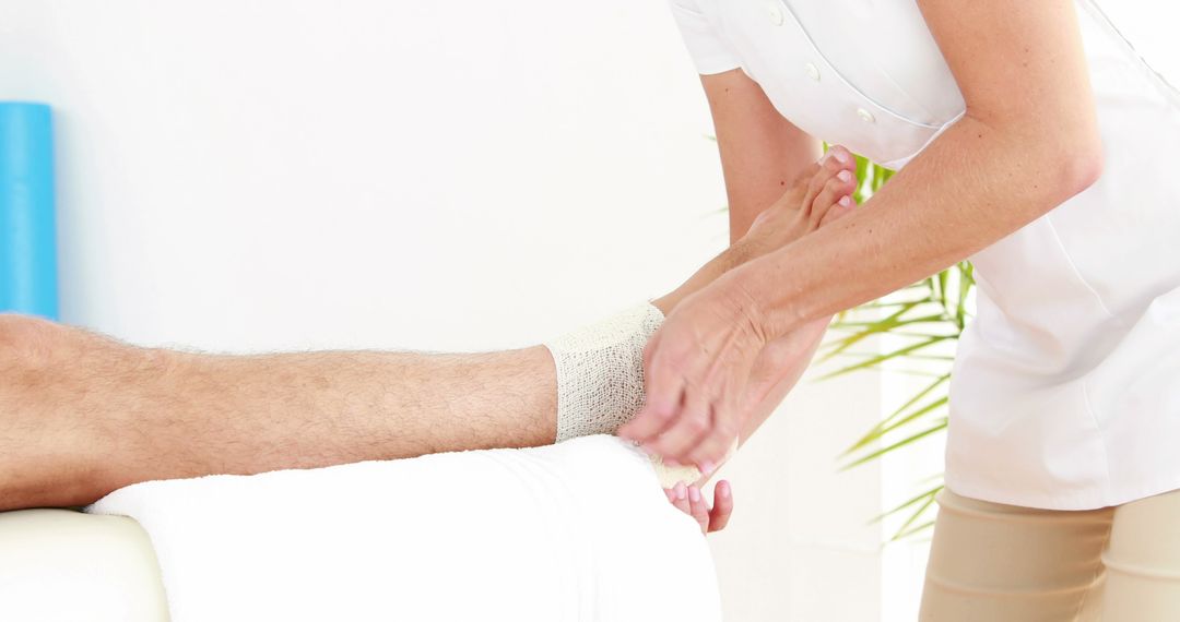 Physical Therapist Treating Patient's Ankle with Bandage - Free Images, Stock Photos and Pictures on Pikwizard.com