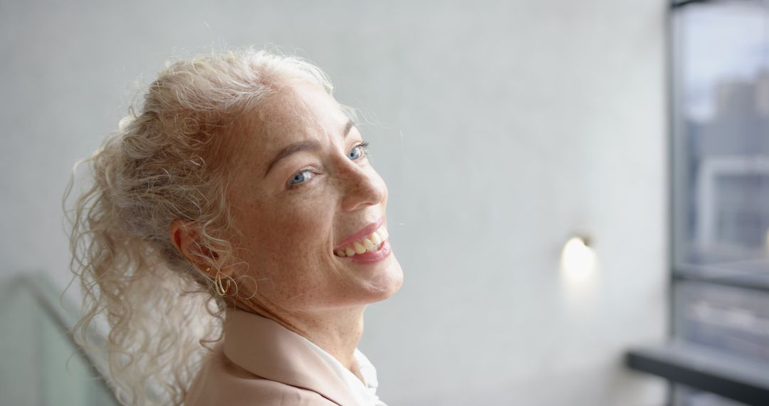 Cheerful Mature Woman Smiling with Curly Hair in Relaxed Mood