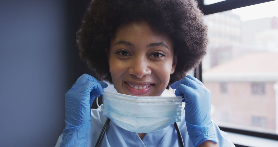 Smiling African American Nurse Adjusting Face Mask - Free Images, Stock Photos and Pictures on Pikwizard.com