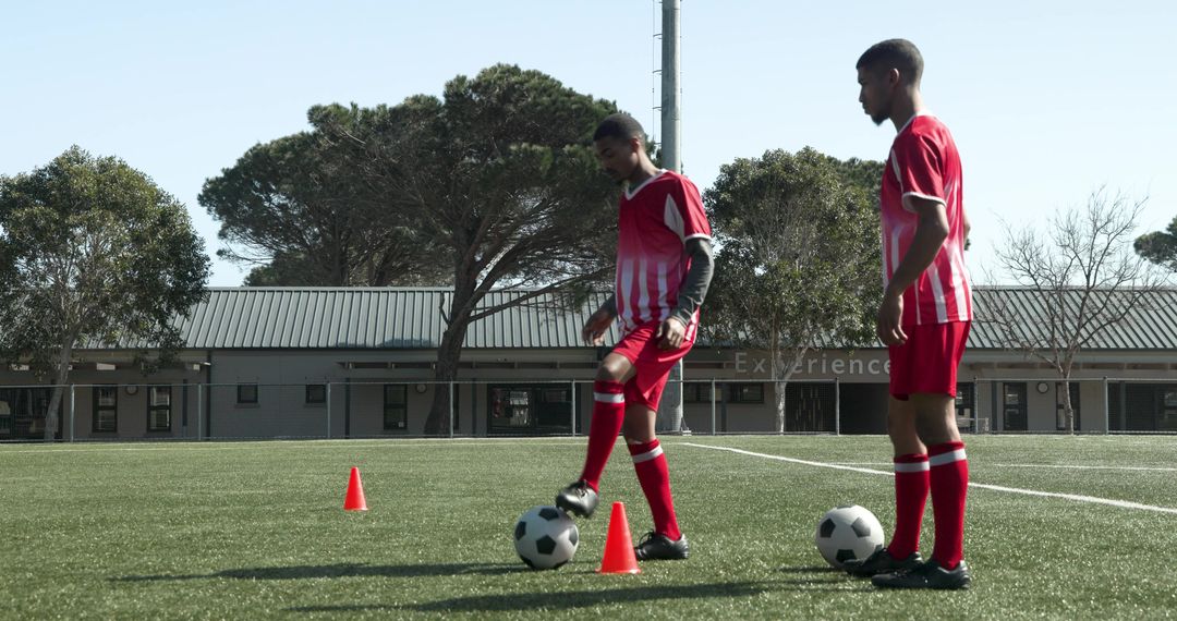 Youth Soccer Players Practicing Footwork on Green Field