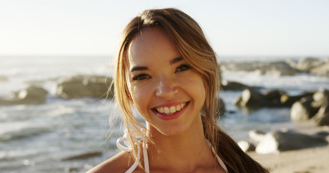 Smiling Woman Enjoying Seaside at Sunset - Free Images, Stock Photos and Pictures on Pikwizard.com