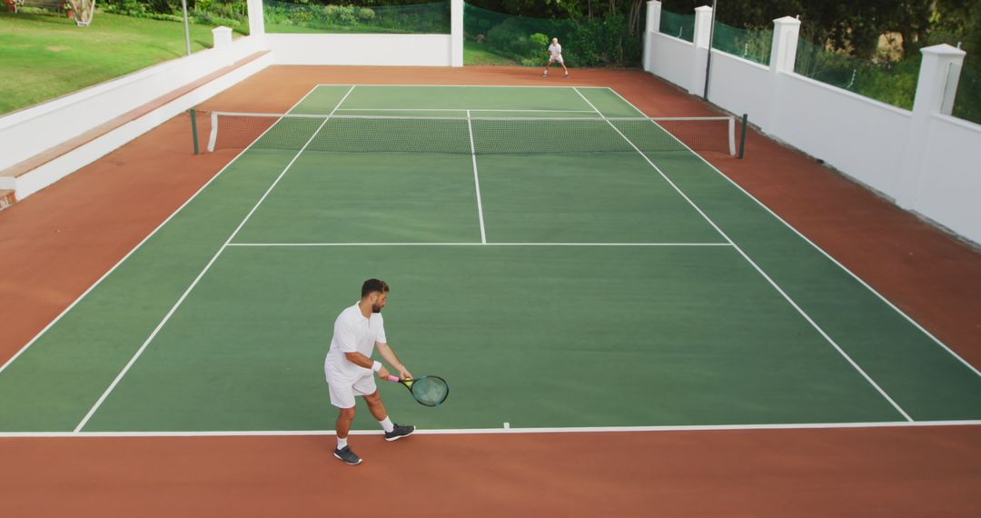 Aerial View of Two Men Playing Tennis on an Outdoor Court - Free Images, Stock Photos and Pictures on Pikwizard.com