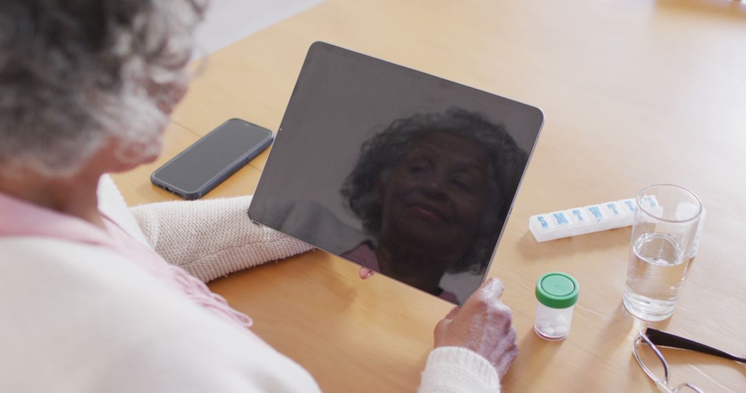 Senior Woman Reflecting on Tablet with Medication Dispenser - Free Images, Stock Photos and Pictures on Pikwizard.com