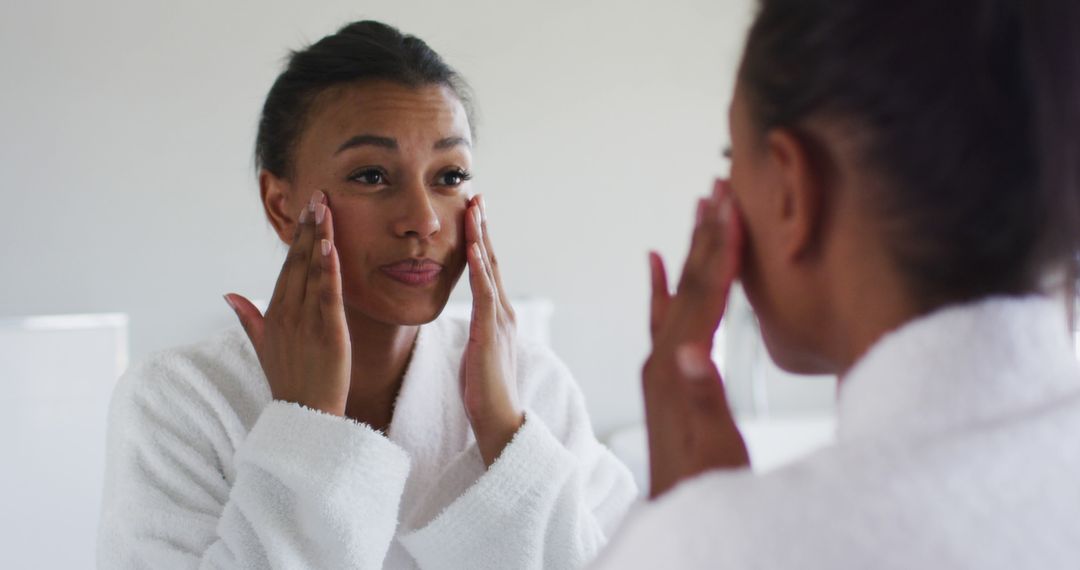 Woman Practicing Skincare Routine in Front of Mirror - Free Images, Stock Photos and Pictures on Pikwizard.com