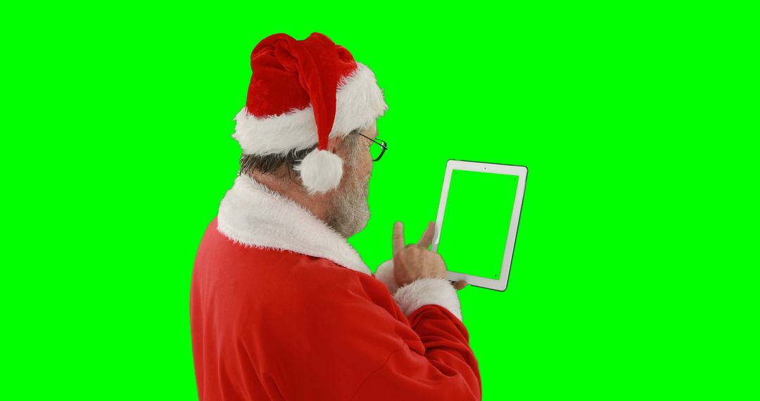 Santa Claus Using Digital Tablet on Green Screen Background - Free Images, Stock Photos and Pictures on Pikwizard.com