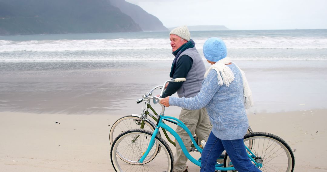 Senior Couple Strolling with Bicycles on Beach - Free Images, Stock Photos and Pictures on Pikwizard.com