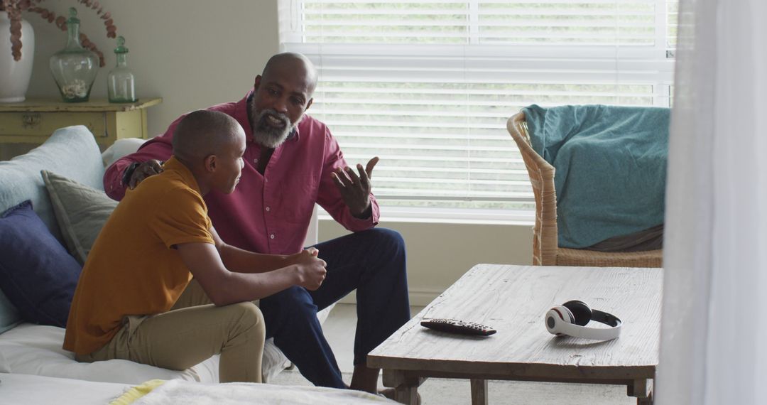 Father and Son Having Serious Conversation in Living Room - Free Images, Stock Photos and Pictures on Pikwizard.com