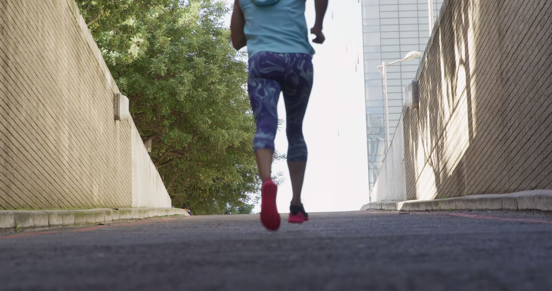 Woman Running on Urban Pathway in Morning - Free Images, Stock Photos and Pictures on Pikwizard.com