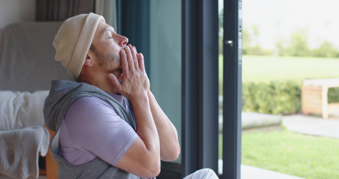 Asian Man Practicing Morning Mindfulness by Open Patio Door