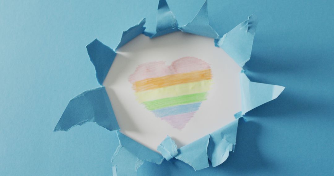 Heart-Shaped Rainbow on Torn Blue Paper Background - Free Images, Stock Photos and Pictures on Pikwizard.com