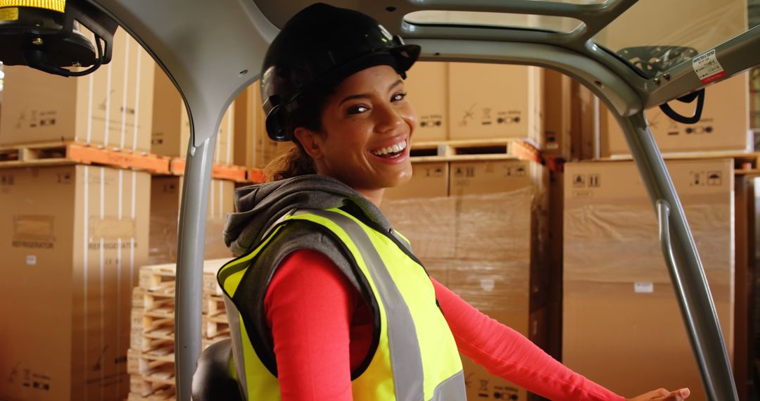 Smiling Female Warehouse Worker Operating Forklift in Storage Facility - Free Images, Stock Photos and Pictures on Pikwizard.com