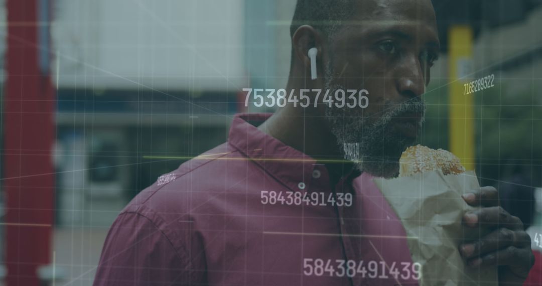 Senior Man Engaging with Modern Technology While Snacking