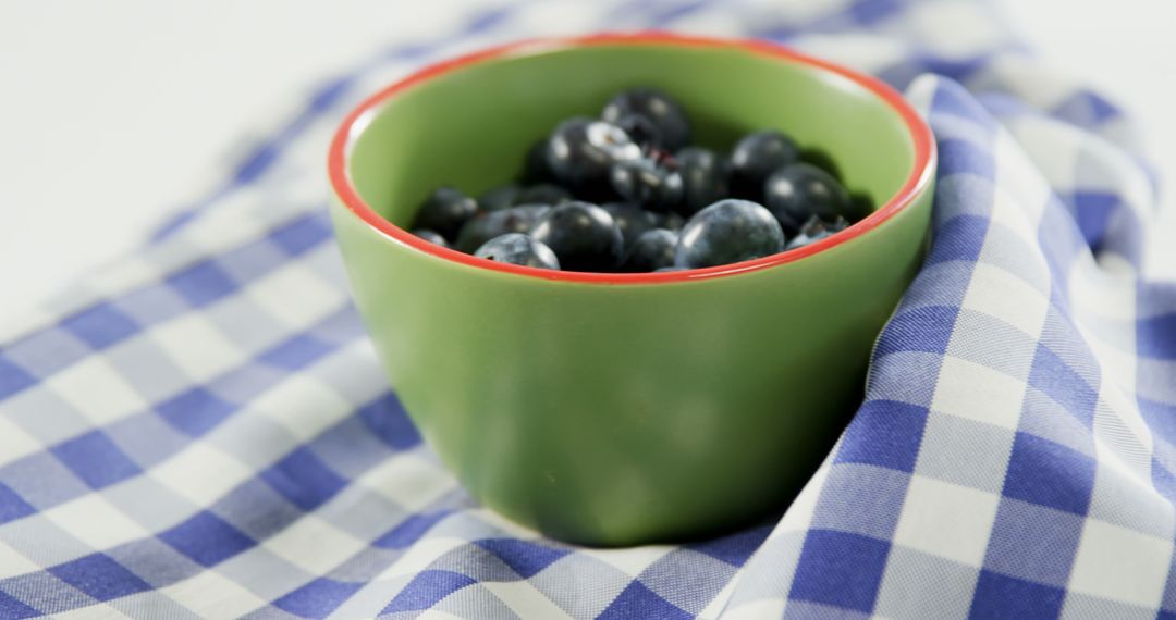 Fresh Blueberries in Green Bowl on Checkered Cloth - Free Images, Stock Photos and Pictures on Pikwizard.com