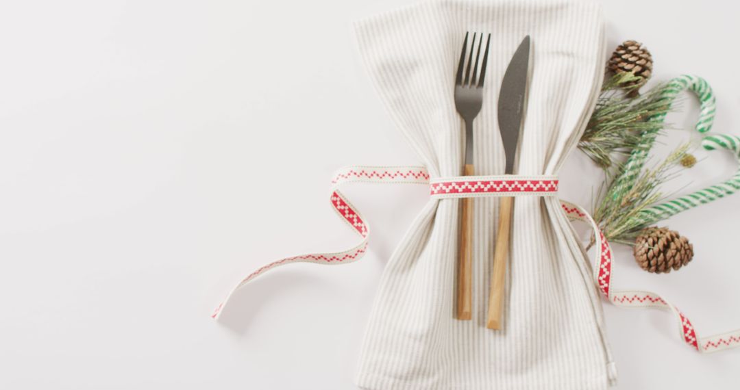 Festive Table Setting with Utensils and Christmas Decor