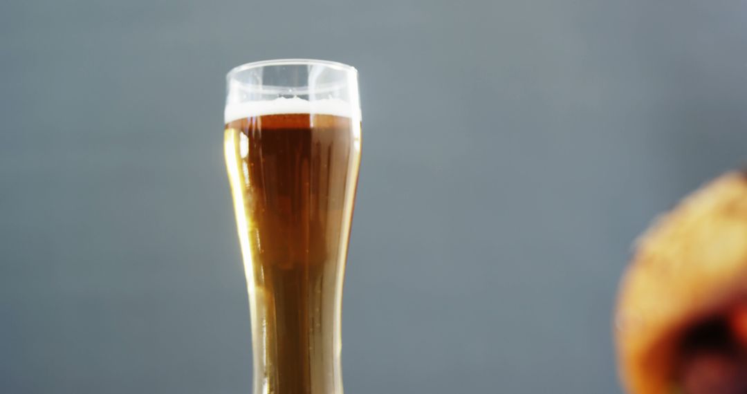 Close-up of Beer Glass with Foam Against Gray Background - Free Images, Stock Photos and Pictures on Pikwizard.com