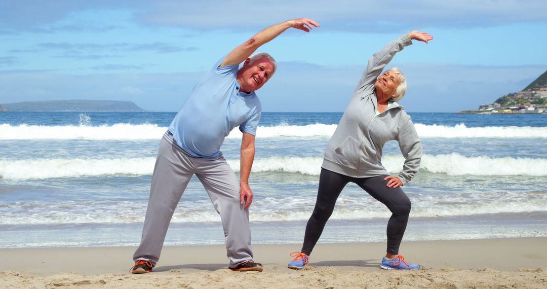 Senior Couple Exercising on Beach - Free Images, Stock Photos and Pictures on Pikwizard.com