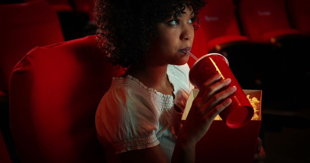 Young Girl Engrossed in Movie Theater Experience - Free Images, Stock Photos and Pictures on Pikwizard.com