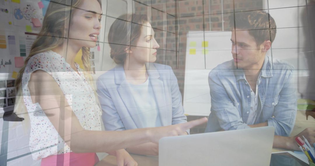 Office Team Collaborating Around Laptop for Innovative Solutions