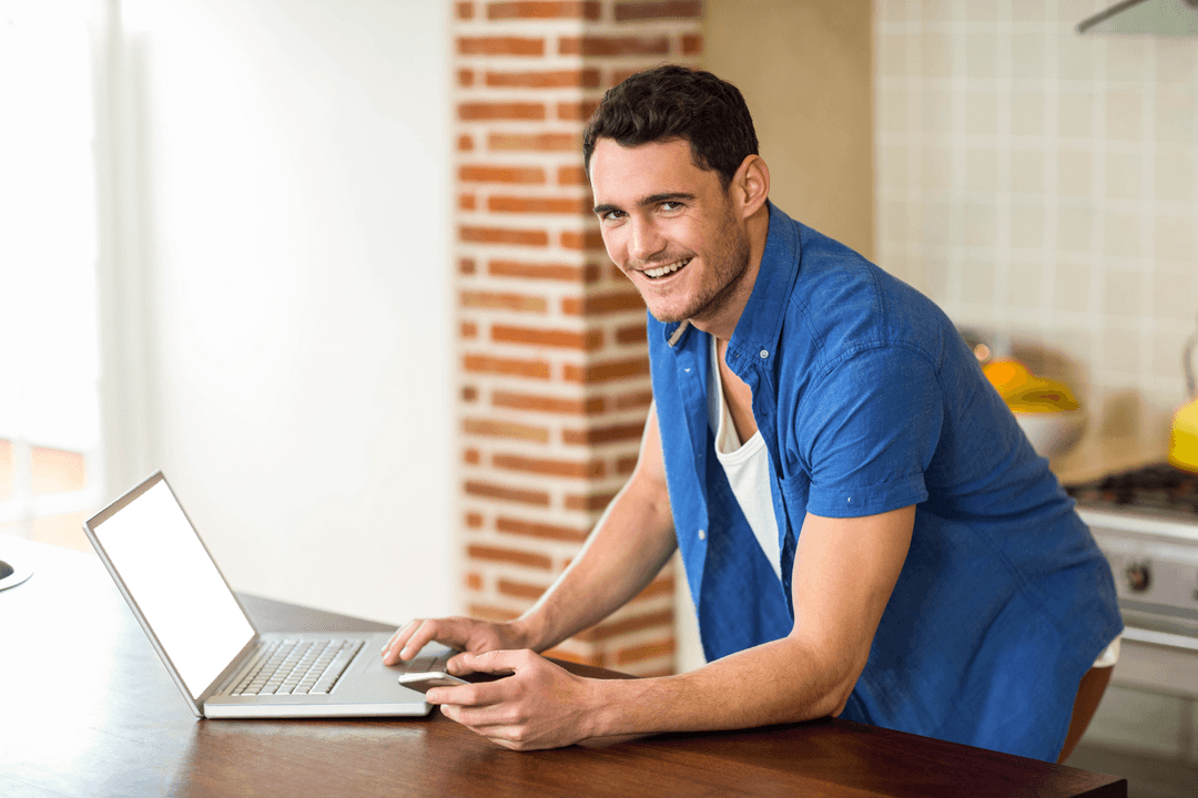 Cheerfully Transparent Man Using Laptop in Modern Kitchen Setting