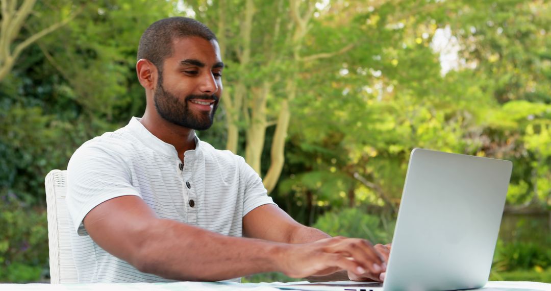 Man Working on Laptop Outdoors in Garden - Free Images, Stock Photos and Pictures on Pikwizard.com