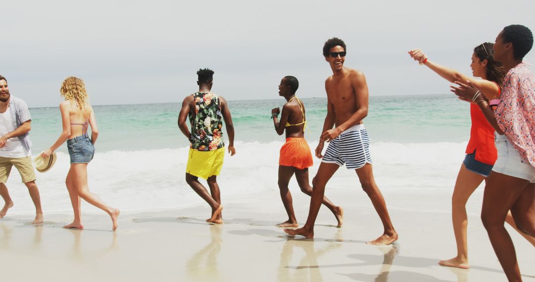 Group of Friends Strolling Along Sunny Beach in Casual Attire