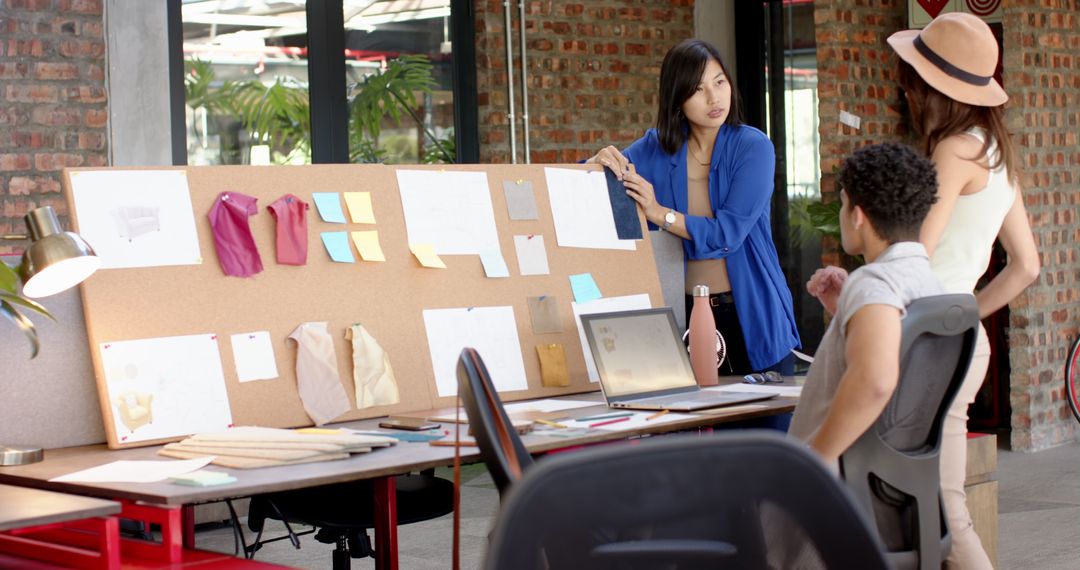 Creative Team Discussing Design Concepts in Modern Studio