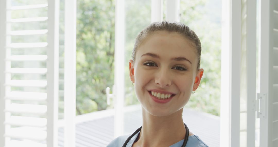 Smiling Nurse Standing in Bright Room - Free Images, Stock Photos and Pictures on Pikwizard.com