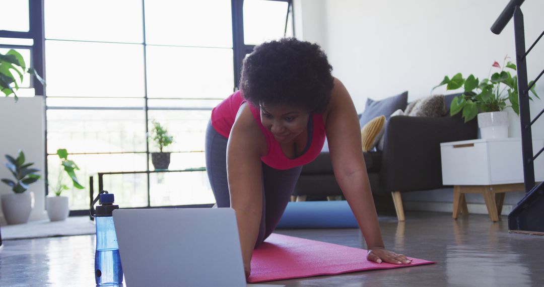 Woman Exercising at Home with Online Fitness Routine - Free Images, Stock Photos and Pictures on Pikwizard.com