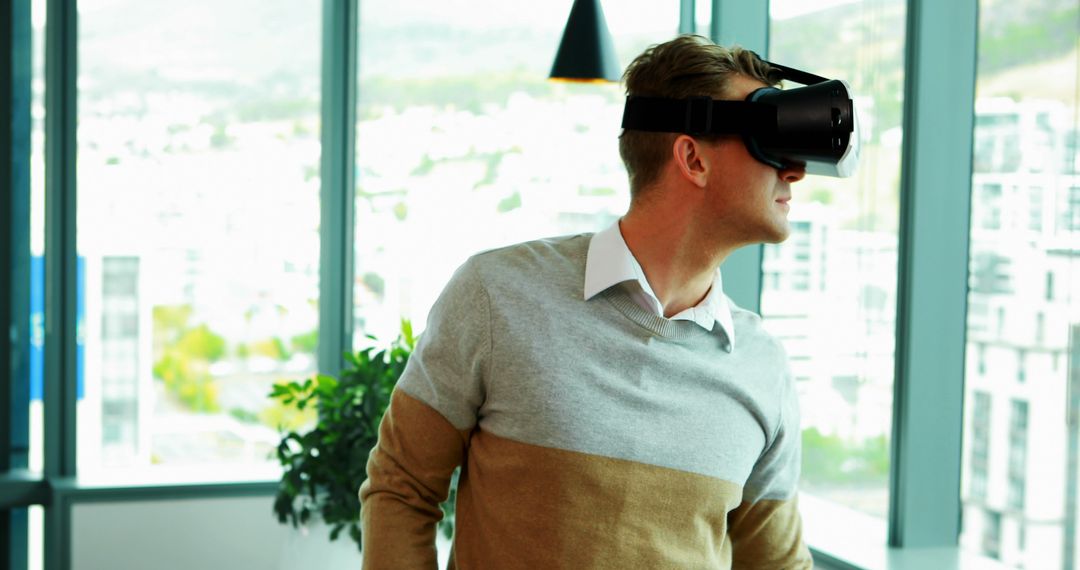 Young Professional Engaging with Virtual Reality in Modern Office