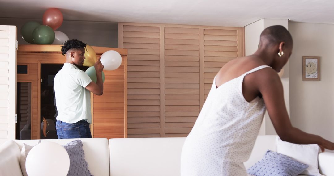 Friends Preparing for Party with Festive Balloon Decorations