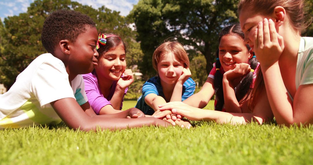 Diverse Group of Children Lying on Grass Enjoying Friendship Outdoors - Free Images, Stock Photos and Pictures on Pikwizard.com