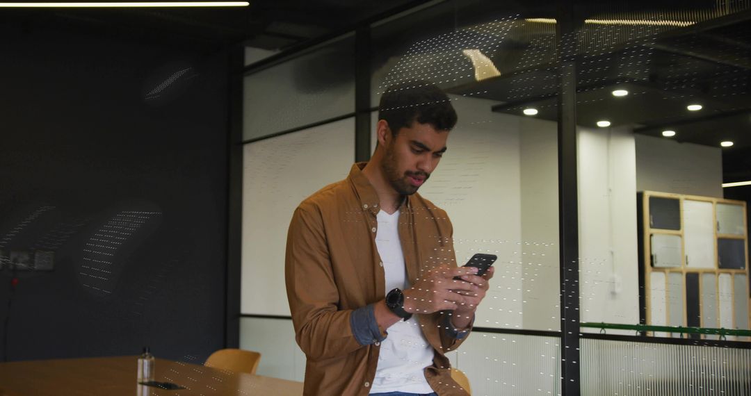 Professional Man Checking Smartphone in Modern Office Environment