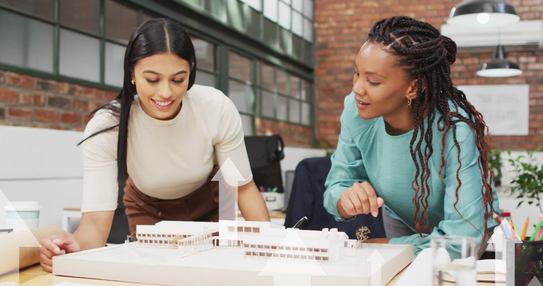 Diverse Female Architects Examining Building Model in Office - Free Images, Stock Photos and Pictures on Pikwizard.com