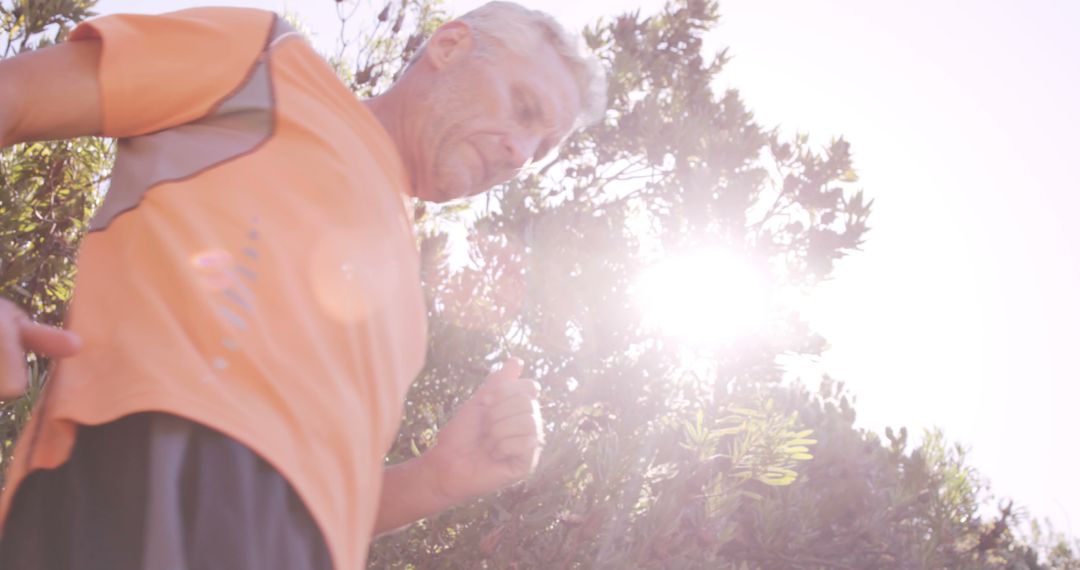 Senior Man Jogging Outdoors on Sunny Day - Free Images, Stock Photos and Pictures on Pikwizard.com