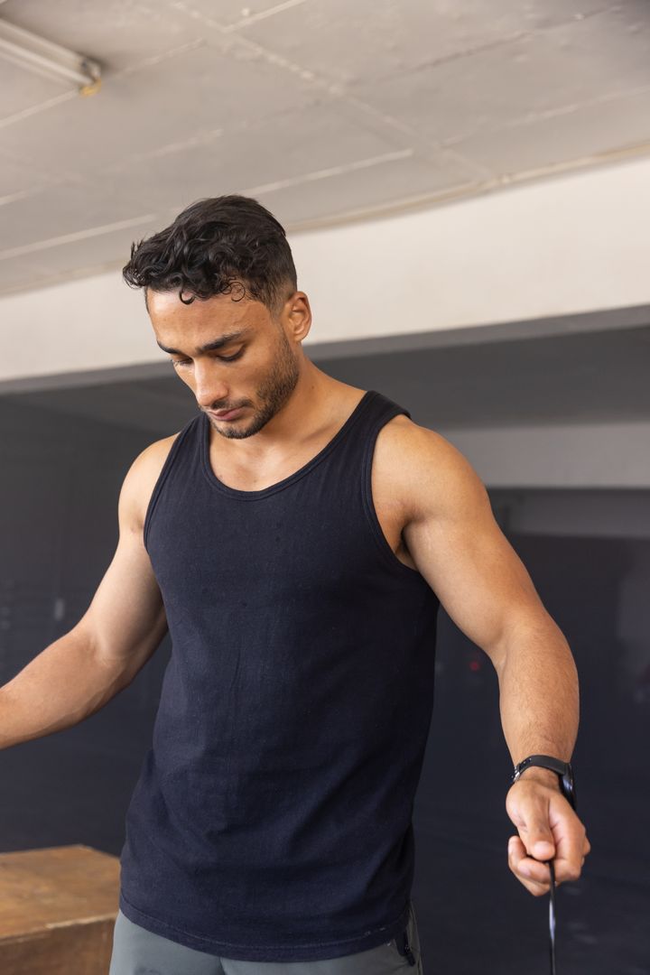 Athlete Adjusting Jump Rope Actions in Garage Gym Setting