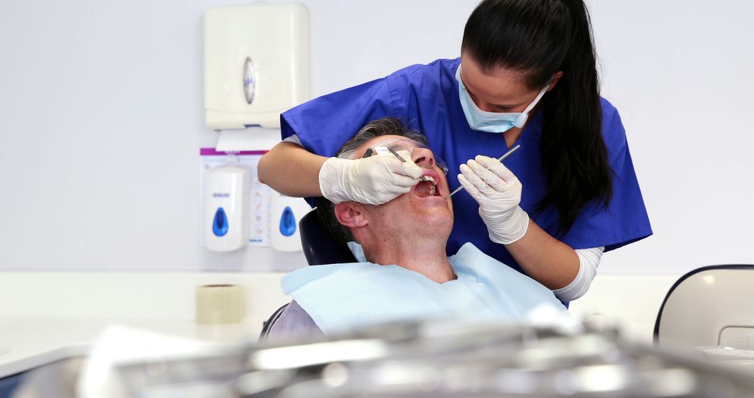 Dentist Treating Patient in Dental Clinic - Free Images, Stock Photos and Pictures on Pikwizard.com