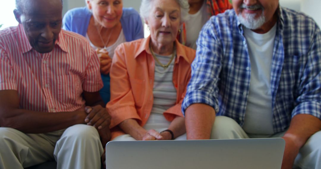 Diverse Seniors Enjoying Shared Online Experience on Laptop