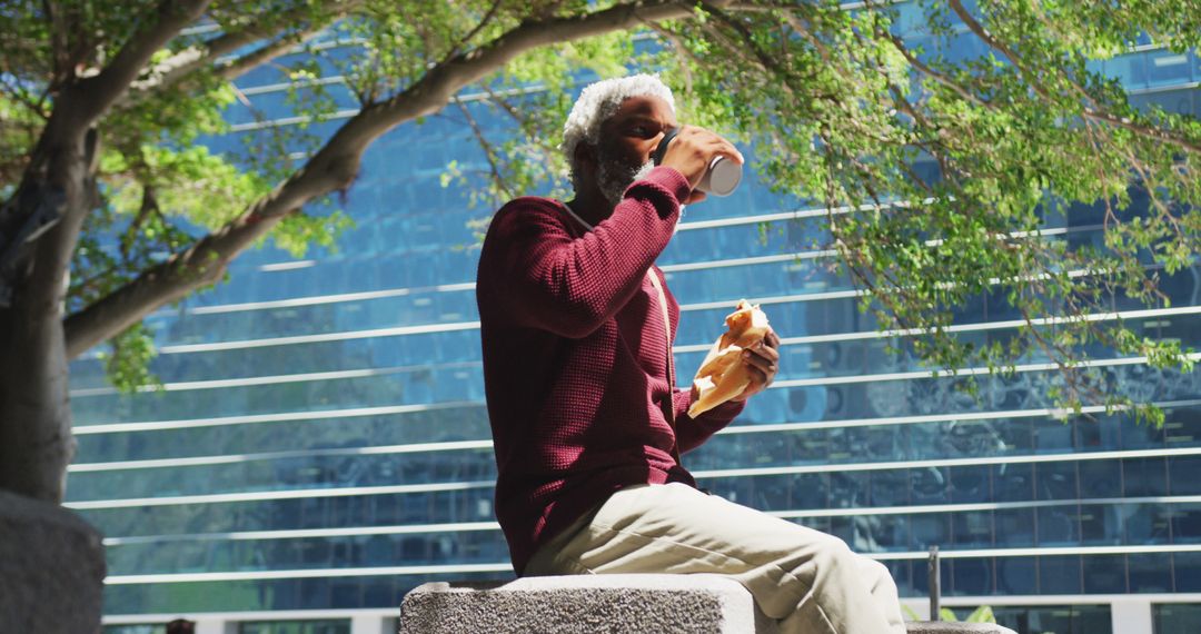 Elderly Man Enjoying Snack Break in Urban Park - Free Images, Stock Photos and Pictures on Pikwizard.com