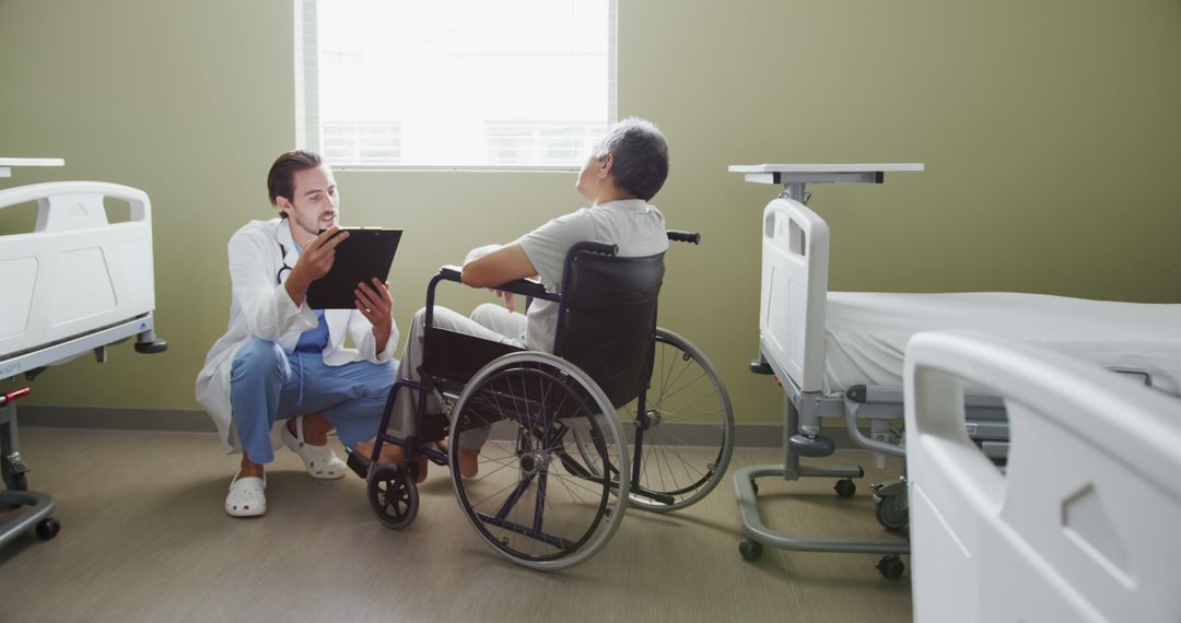 Doctor Consulting with Elderly Patient in Wheelchair in Hospital Room - Free Images, Stock Photos and Pictures on Pikwizard.com