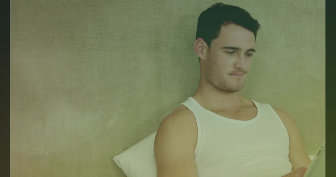 Young Man Relaxing Using Tablet at Home in Casual Environment