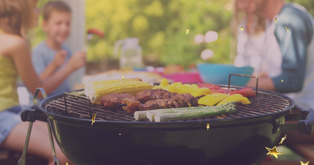 Family Enjoying Barbecue Cookout in Sunny Backyard