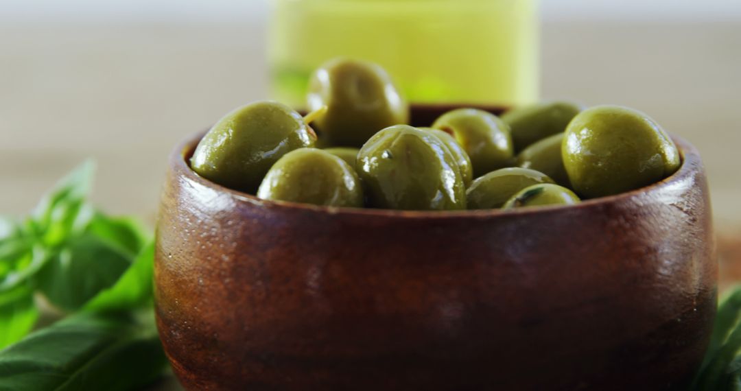 Rustic Wooden Bowl Filled with Fresh Green Olives - Free Images, Stock Photos and Pictures on Pikwizard.com