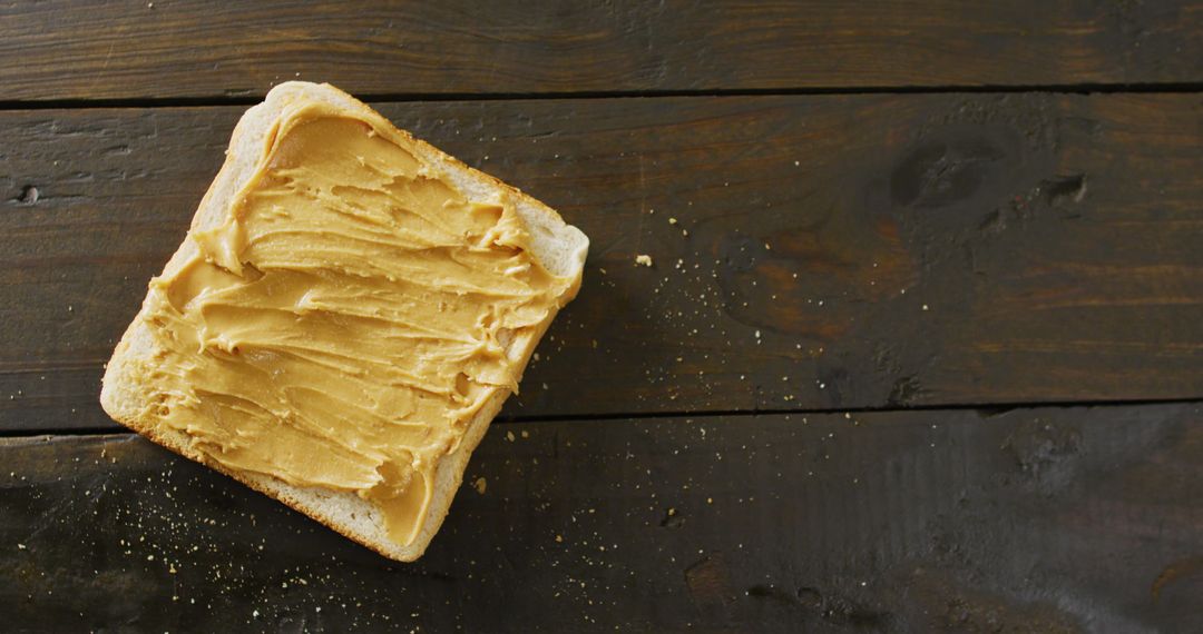 Close-Up of Toast with Creamy Peanut Butter on Rustic Wooden Table
