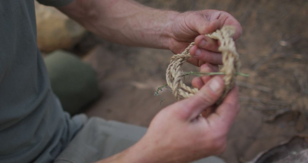 Hands Crafting Hemp Rope in Outdoor Survival Situation - Free Images, Stock Photos and Pictures on Pikwizard.com