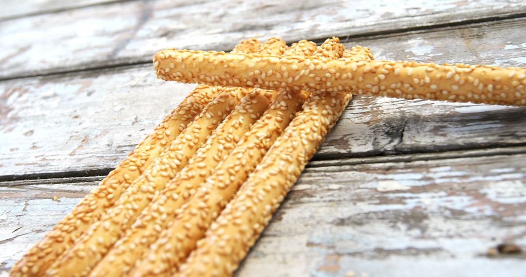 Crispy Sesame Breadsticks on Rustic Wooden Surface - Free Images, Stock Photos and Pictures on Pikwizard.com