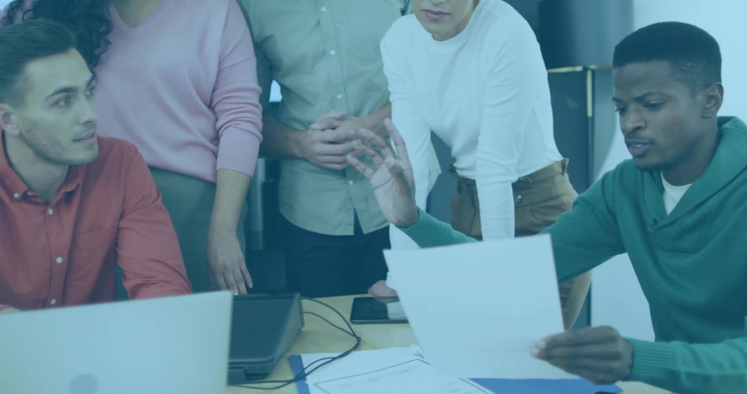 Team Reviewing Documents Discussing Strategy and Project Planning in Modern Office