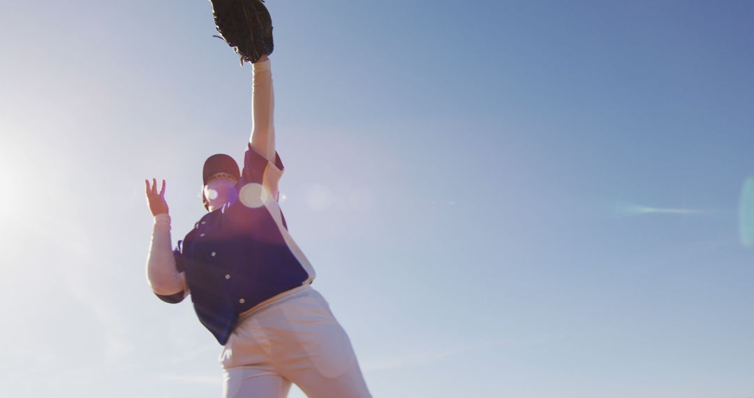 Baseball Player Catching Ball Under Clear Skies - Free Images, Stock Photos and Pictures on Pikwizard.com